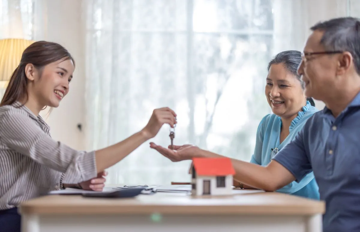 Un notaire remet les clés à un couple